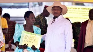 One of the beneficiaries receiving the certificate of customary ownership from the President of Uganda, H.E Yoweri Kaguta Museveni